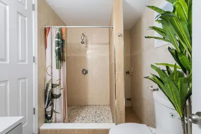 a bathroom with a shower with a plant at Queen Bedroom w Ensuite Bathroom - Mins from NYC in Jersey City