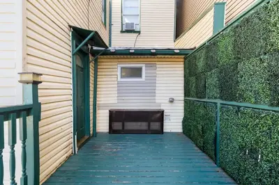 a walkway leading up to a building with a fence at Queen Bedroom w Ensuite Bathroom - Mins from NYC in Jersey City