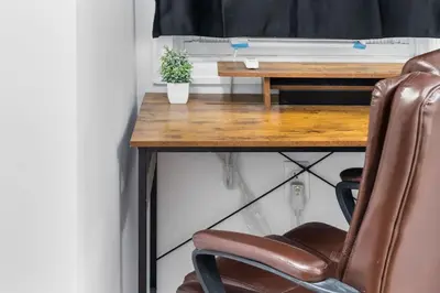 a desk with a chair in front of a table at Queen Bedroom w Ensuite Bathroom - Mins from NYC in Jersey City
