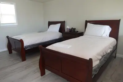 two beds sitting next to each other in a room at Freedom INN Motel in Grantville