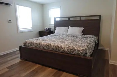 a bedroom with a large bed with a wooden headboard at Freedom INN Motel in Grantville