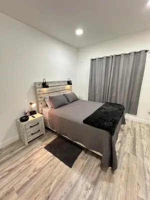 a bedroom with a bed and a dresser and a window at Beautiful and comfortable room, close to New York Hermosa y cómoda habitación, cerca a New York in West New York