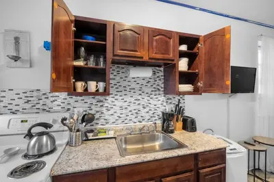 a kitchen with a sink and a counter top at Modern 2BR 10 Mins to Metro in Philadelphia