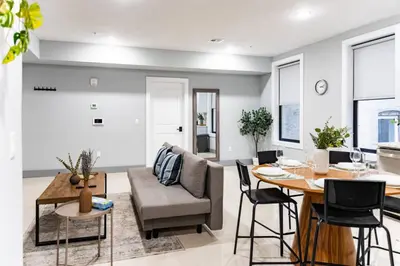 a living room with a couch and a table at City Life-2 Bedrooms-Free Indoor Parking-20minNYC in West New York