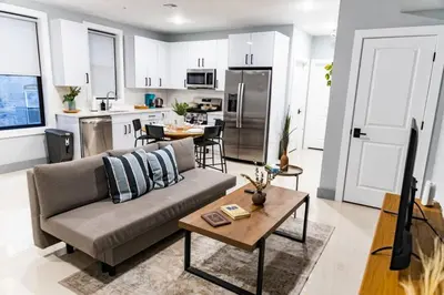 a living room with a couch and a table at City Life-2 Bedrooms-Free Indoor Parking-20minNYC in West New York