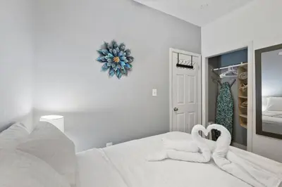 two towel swans sitting on a bed in a bedroom at Renovated 2BR w Amenities in Philadelphia
