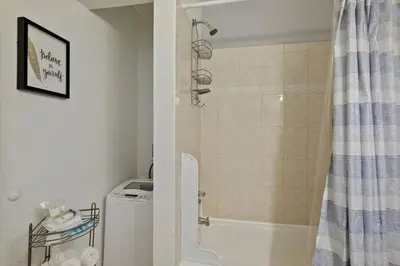 a bathroom with a shower and a toilet and a sink at Renovated 2BR w Amenities in Philadelphia