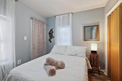 a bedroom with a bed with a towel on it at Renovated 2BR w Amenities in Philadelphia