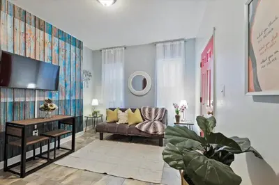 a living room with a couch and a tv at Renovated 2BR w Amenities in Philadelphia
