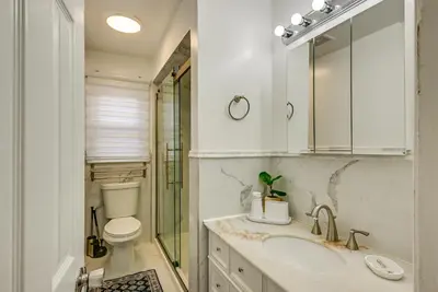 a bathroom with a sink and a toilet and a mirror at Walk to Public Transit Apt Next to Lincoln Park in Jersey City