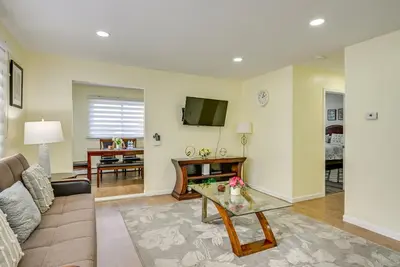 a living room with a couch and a table at Walk to Public Transit Apt Next to Lincoln Park in Jersey City