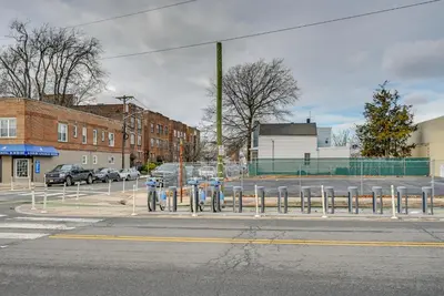 a row of parking meters on a city street at Stay and Play in Jersey City! Walk to PATH and Park in Jersey City