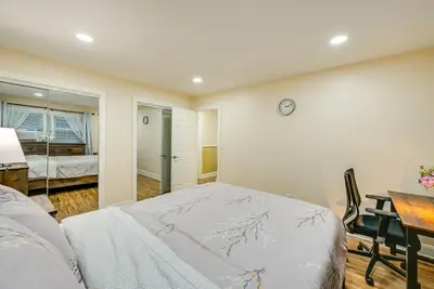 a bedroom with a bed and a desk and a table at Walkable Jersey City Stay Near Parks and Dining! in Jersey City