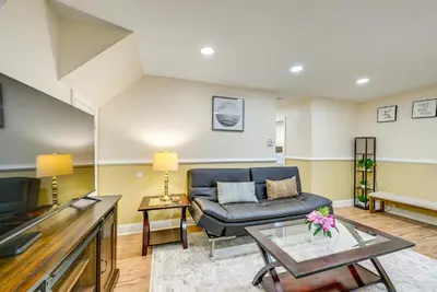 a living room with a couch and a table at Walkable Jersey City Stay Near Parks and Dining! in Jersey City