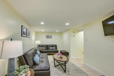 a living room with a couch and a table at Walk to Lincoln Park Jersey City Commuter Apt! in Jersey City