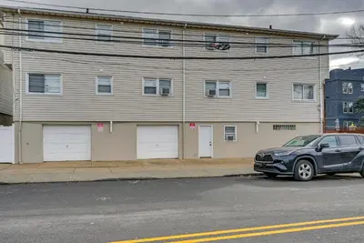 a car parked in front of a building at Walk to Lincoln Park Jersey City Commuter Apt! in Jersey City