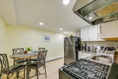 a kitchen with a table and a stove at Walk to Lincoln Park Jersey City Commuter Apt! in Jersey City