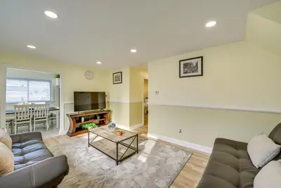 a living room with a couch and a table at 6 Mi to Lower Manhattan Pet-Friendly Apt! in Jersey City