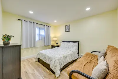 a bedroom with a bed and a couch at 6 Mi to Lower Manhattan Pet-Friendly Apt! in Jersey City