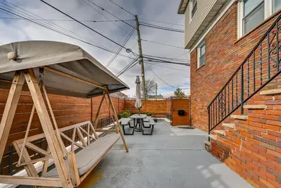 a patio with a picnic table and a brick building at 6 Mi to Lower Manhattan Pet-Friendly Apt! in Jersey City