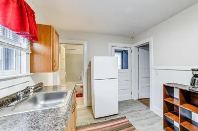 a kitchen with a white refrigerator and a sink at Work and Study Binghamton Apt 2 Mi to Downtown in Binghamton