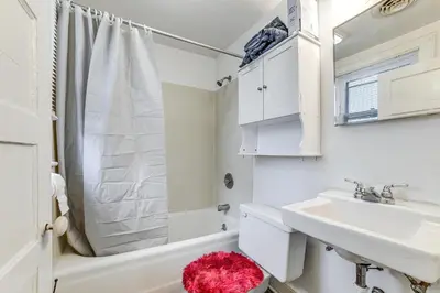 a white bathroom with a sink and a shower at Work and Study Binghamton Apt 2 Mi to Downtown in Binghamton