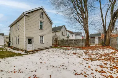 a house with snow on the ground in a yard at Work and Study Binghamton Apt 2 Mi to Downtown in Binghamton