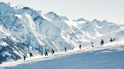 a group of people skiing down a snow covered mountain at Private 10 guest Getaway Fire-Pit Golf Hike Ski Spa in Vernon