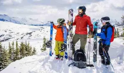 a group of people standing in the snow with skis at Luxe 10 guest Ski Cabin - Snowboarding Hiking Pools Golf Tennis in Vernon Township