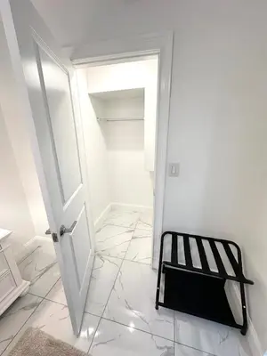 a white room with a white door and a black chair at Luxury escape near New York City in Weehawken