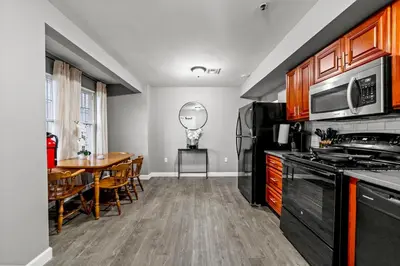 a kitchen with a table and a dining room at Modern 2BR, King Suite and Free Parking, 30min to NYC in Newark