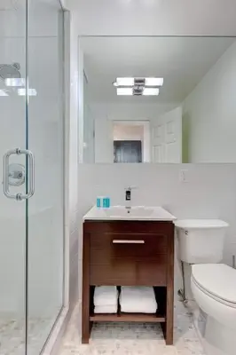 a bathroom with a sink and a toilet and a shower at East Village by Vibe I in New York