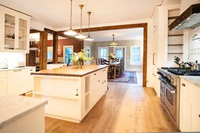 a kitchen with white cabinets and a kitchen island with flowers at LaValleyEstates in Long Eddy