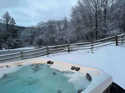 a jacuzzi tub in the snow with a fence at LaValleyEstates in Long Eddy