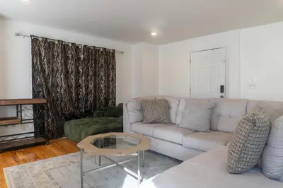 a living room with a couch and a table at Spacious 3BR Home Near Newark Airport in Newark