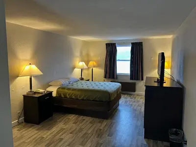 a hotel room with a bed and a television at Economy Inn of Reading in Reading