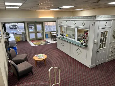 an office with a waiting area with chairs and a table at Economy Inn of Reading in Reading