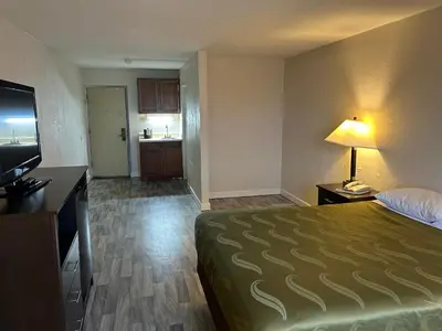 a hotel room with a bed and a television at Economy Inn of Reading in Reading