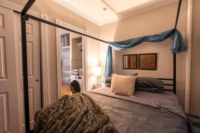 a bedroom with a bed with a canopy at Prestige Gramercy Park Suites in New York