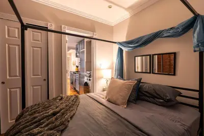 a bedroom with a bed with a canopy at Prestige Gramercy Park Suites in New York