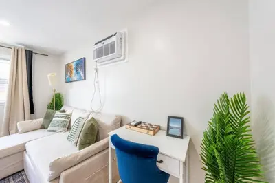 a living room with a couch and a table at Modern 2BR 8 mins to Penn Station with WiFi and Laundry in Newark