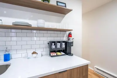 a kitchen with a sink and a counter top at Modern 2BR 8 mins to Penn Station with WiFi and Laundry in Newark