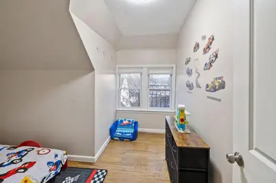 a bedroom with a bed and a desk and a window at Modern 2BR Near NYC with Free Parking and Workspace in East Orange