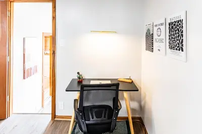 a desk in a room with a black chair at Charming 2 Bedroom Apartment Near NYC, Metlife Stadium in Hackensack