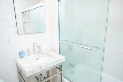 a bathroom with a sink and a shower at West47 Village Getaway - Subway & Local Cafés in New York
