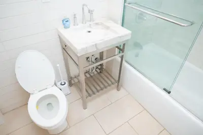 a bathroom with a toilet and a sink and a shower at West47 Village Getaway - Subway & Local Cafés in New York