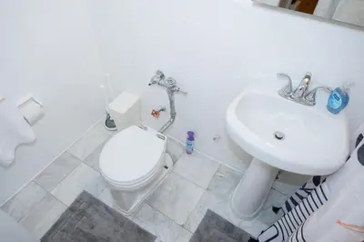 a bathroom with a white toilet and a sink at Chic12 East Village Apartment Near Union Square Top Dining n Shopping in New York