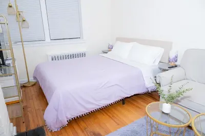 a white bedroom with a bed and a couch at Chic12 East Village Apartment Near Union Square Top Dining n Shopping in New York