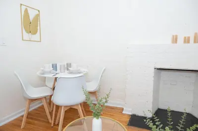a dining room with a table and chairs and a fireplace at Chic12 East Village Apartment Near Union Square Top Dining n Shopping in New York