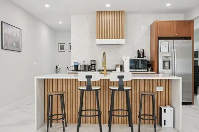a kitchen with a counter with bar stools at Easy-Access & Quick to NYC, EWR, Dream Mall, Stadium in Jersey City
